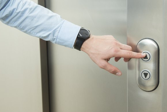 Man Pressing Elevator Button